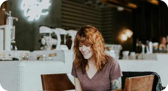 Girl smiling in front of a laptop