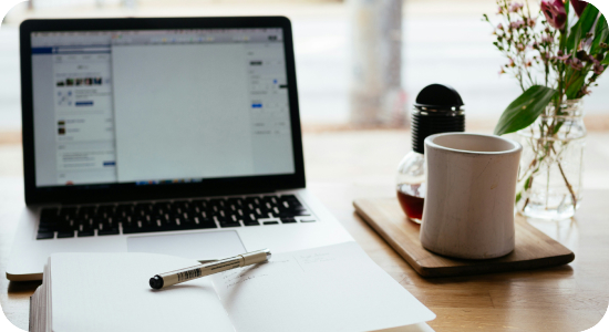 Laptop and a cup of coffee on a desk